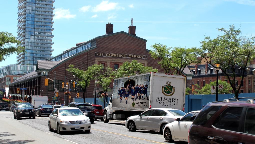 Truckside Advertisements for Albert College outside of St Laurence Market in Toronto