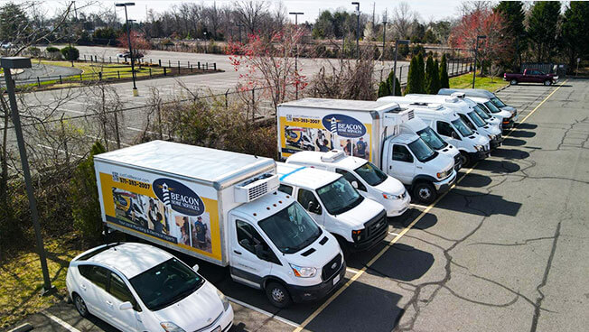 Truckside Ads for Beacon Home Services in a Michigan Parking Lot