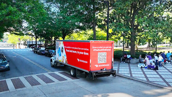 Movia Mobile Billboards for DoorDash near a park with people.