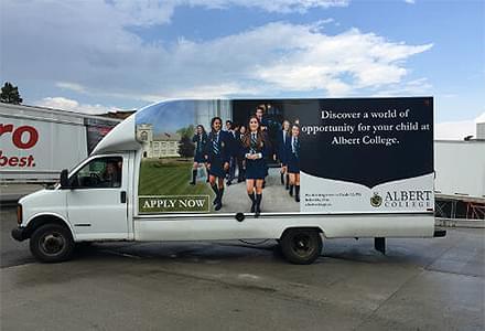 Delivery truck with ad for Albert College.