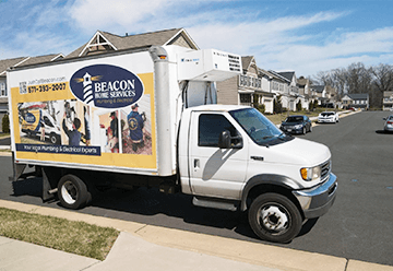 Mobile billboard advertisement for Beacon Home Services on side of truck