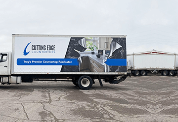 Mobile billboard advertisement for Cutting Edge Countertops on side of truck