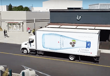 Mobile billboard advertisement for Clearly Canadian on side of truck