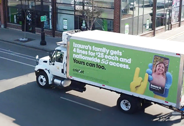 Mobile billboard advertisement for cricket on side of truck