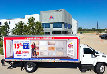 Mobile billboard advertisement for Express Flooring on side of truck