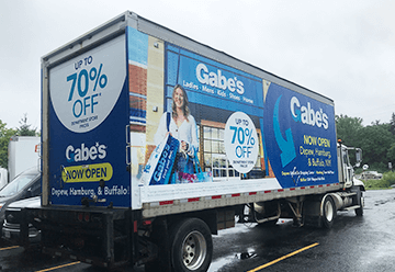 Mobile billboard advertisement for Gabes on side of truck