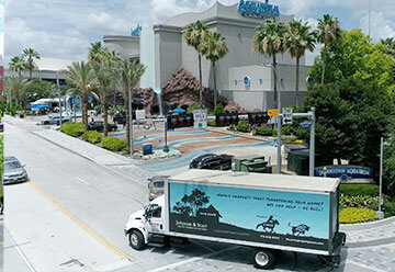 Mobile billboard advertisement for  Johnson & Starr on side of truck