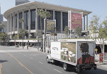 Mobile billboard advertisement for Kotn on side of truck