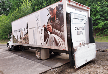 Mobile billboard advertisement for Leatherman on side of truck