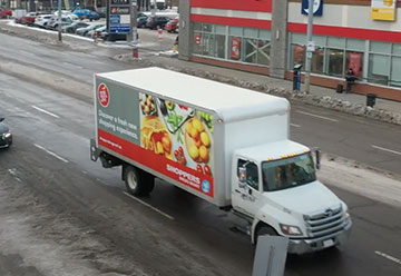 Truckside Advertising for ShoppersDrugMart and Loblaws in front of a Shoppers Drug Mart Store