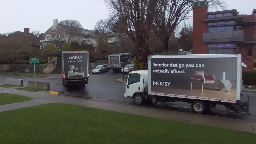 Three Truckside Advertisements for Modsy in residential neighborhoods in Seattle