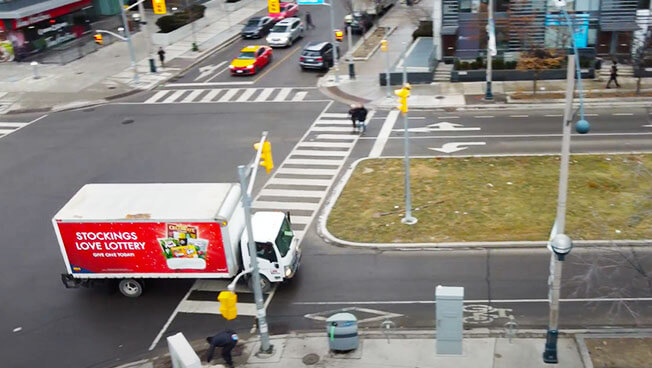 Truck Advertising for OLG Holiday Gifting in a busy intersection