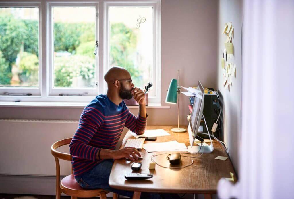 Man sitting in front of computer at home working.