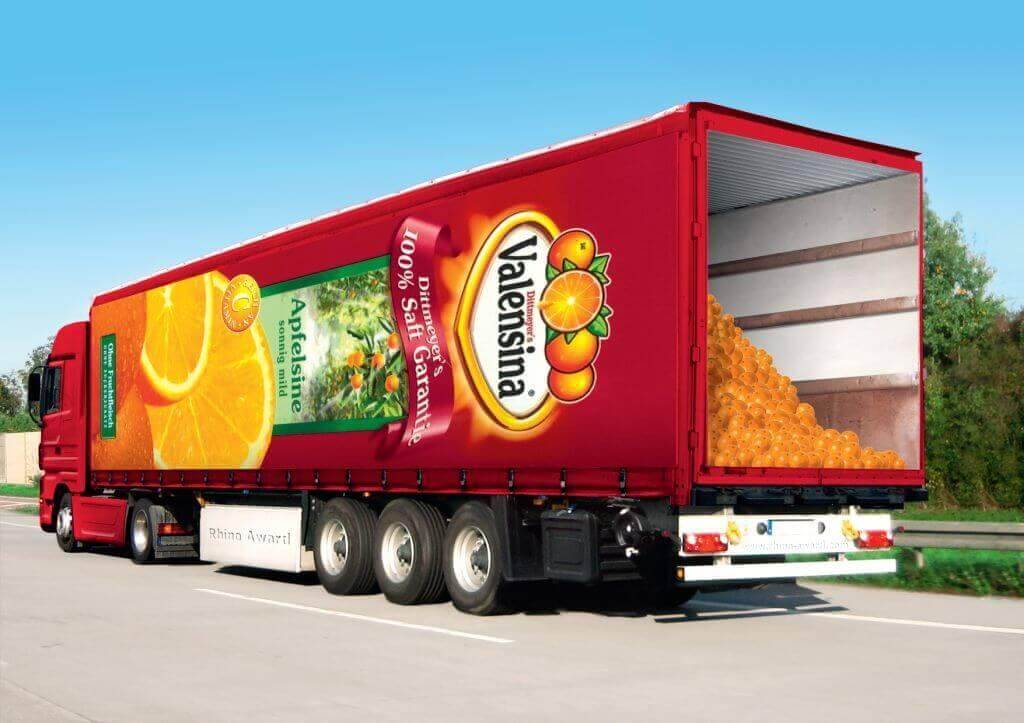 Image of a red 18 wheeler truck displaying an advertisement for Valensina orange juice.