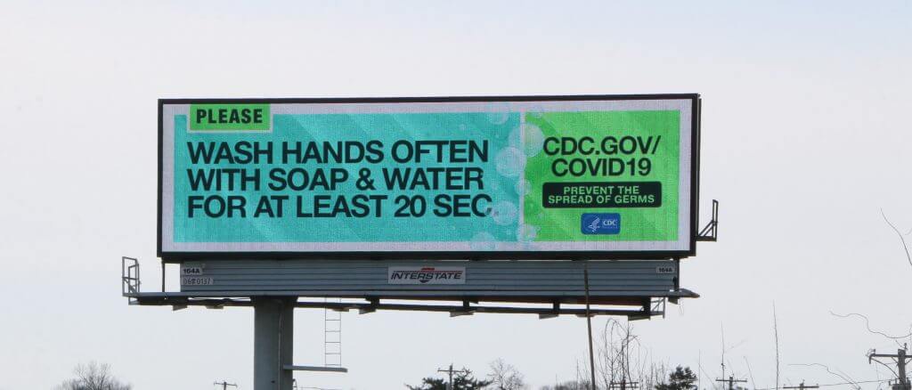 An image of a billboard ad by the CDC asking people to wash their hands properly to reduce the spread of COVID-19.