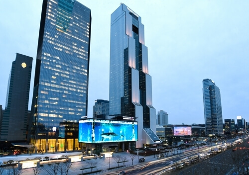An image of K-Pop Square in Seoul with a huge digital OOH billboard.