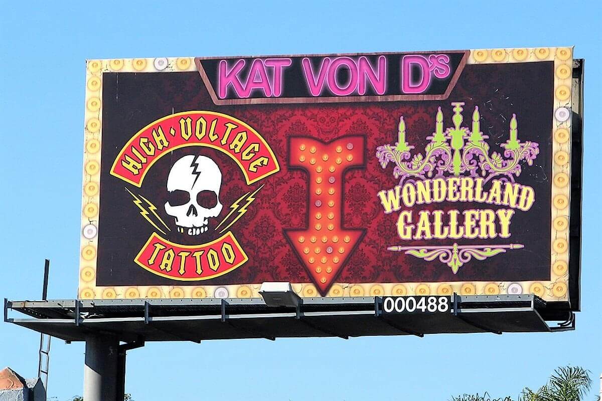 This tattoo parlour billboard allures potential consumers due to its vibrant display