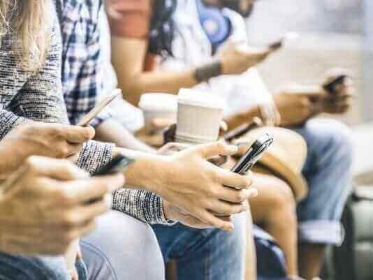 People using smartphones together