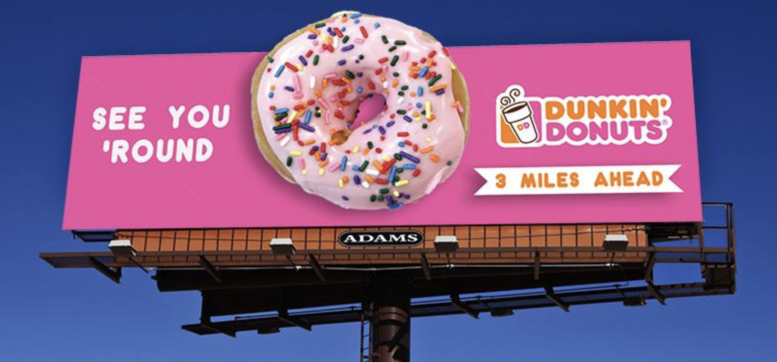 a static Billboard advertising Dunkin' Donuts