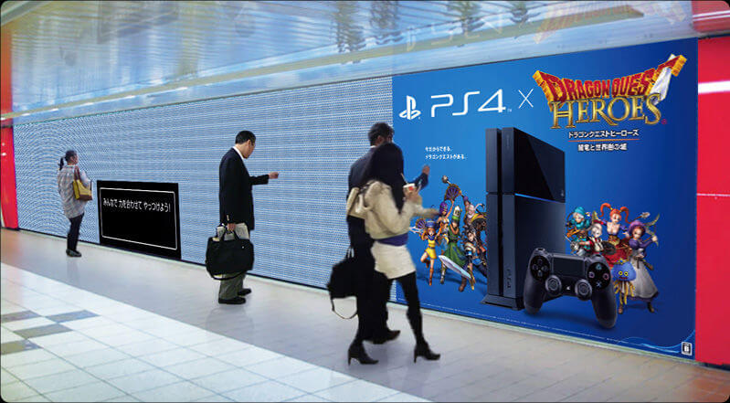 An image of an interactive OOH ad for Dragon Quest Heroes. The wall is covered in poppable bubbles.