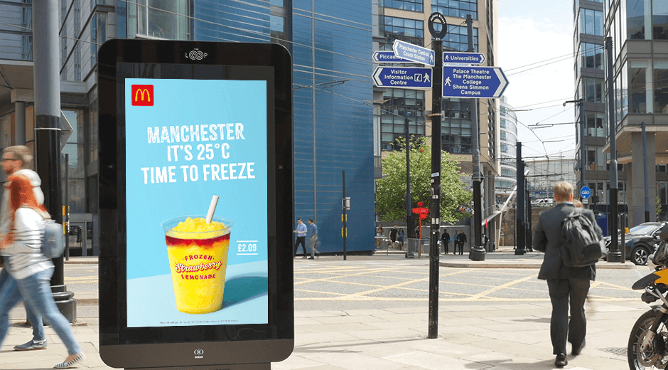 A DOOH sign for McDonald's new frozen drinks with the temperature of Manchester on it.