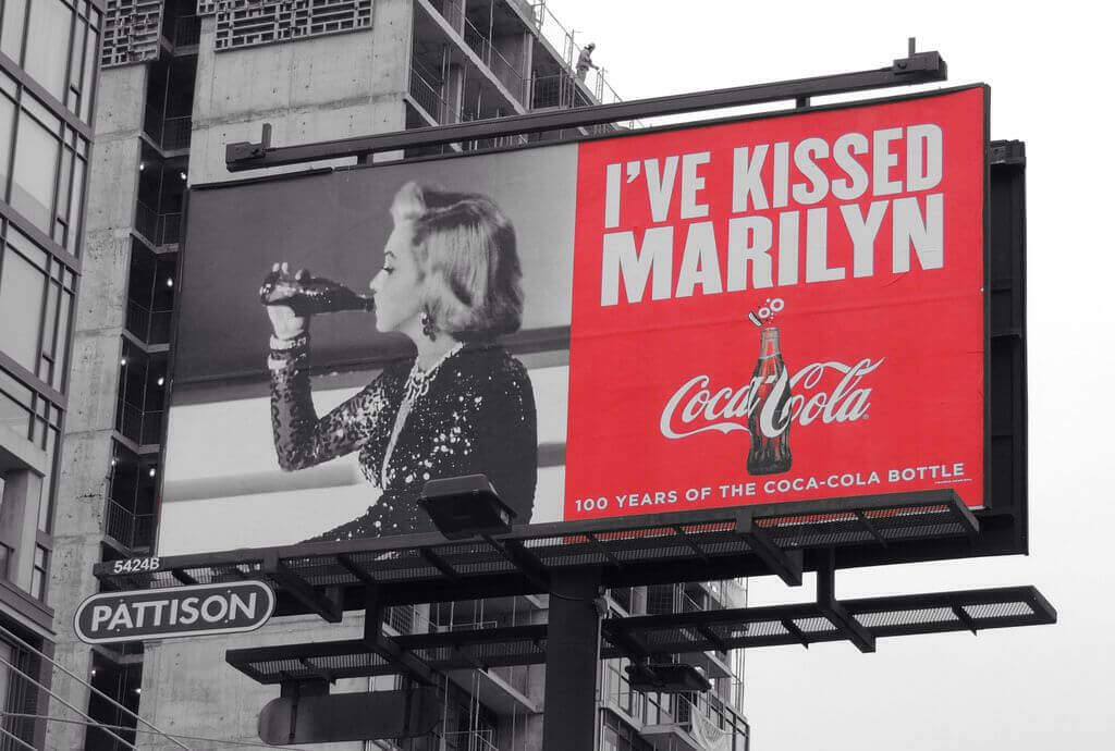 100 years of the Coca Cola bottle celebrated by the 'Kissed By' Coca-Cola OOH campaign featuring Marilyn Monroe. 