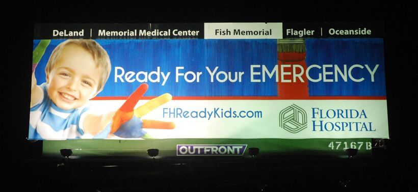 An image of a billboard ad for Florida Hospital with a kid reaching his hands out on the left-hand side.
