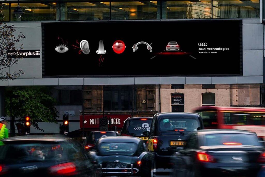 A DOOH ad for Audi that's been placed in rush hour traffic with all the sensory signs.