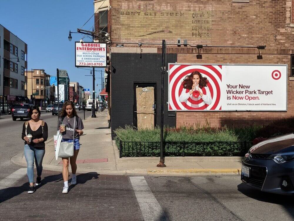 An image of a street corner that focuses on a billboard ad for target on the side of the corner building.