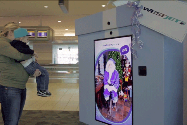 An image of a DOOH interactive ad by WestJet with Santa talking live.