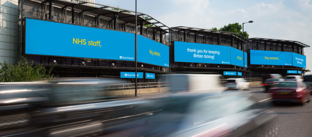 An image of multiple DOOH signs beside a highway created by ClearChannel. 