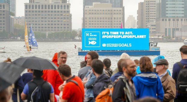 Greta Thunberg arriving in a floating digital billboard for climate change.
