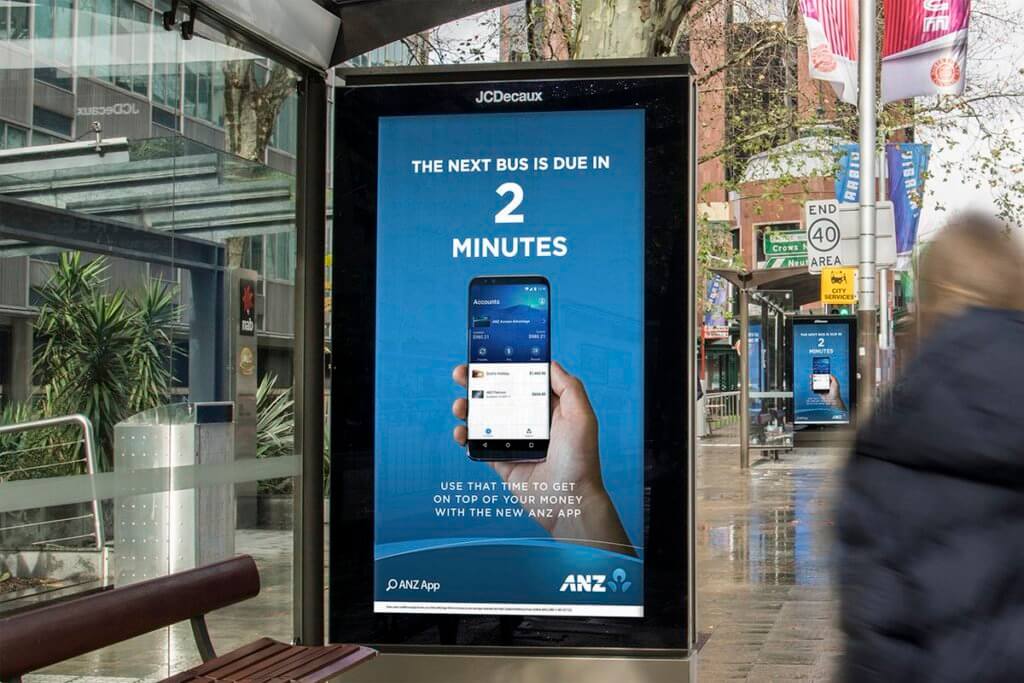 An image of a DOOH billboard ad for ANZ. The billboard changes depending on how soon the next bus is coming.