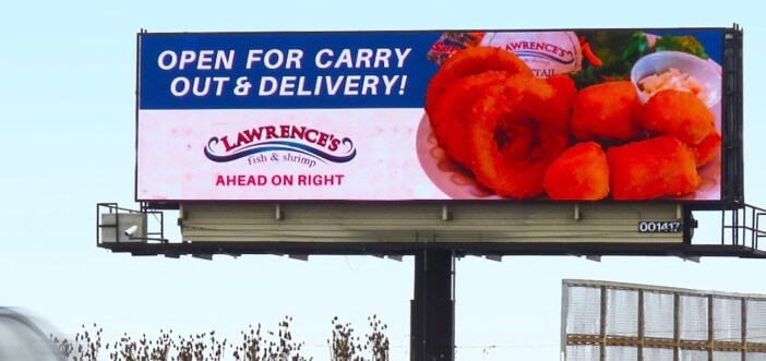 An image of a large billboard for Lawrence's fish & shrimp. Image of seafood on the side.