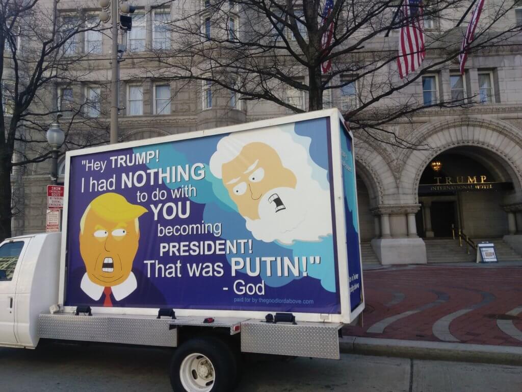 An image of a mobile ad that's making fun of Trump. Has a cartoon image of Trump and one of God and they're bickering.