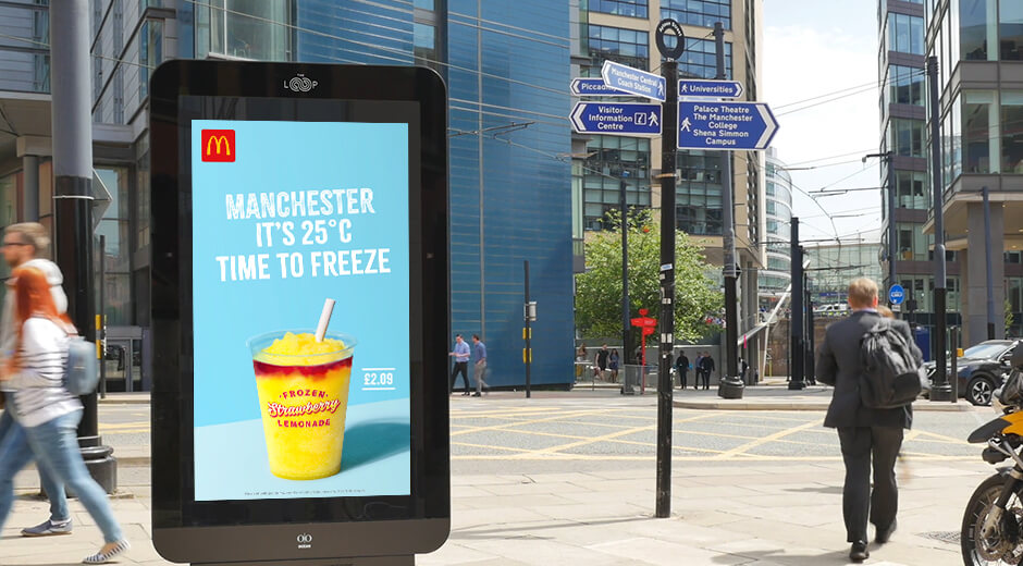 An image of a DOOH billboard ad for McDonald's with a frozen lemonade on it and the temperature in Manchester.