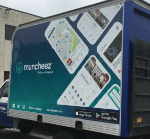 An image of a truck-side ad for Muncheez with a bunch of phones on it with maps open.