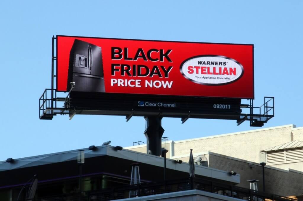 An image of a large billboard for Warner's appliances. The ad is promoting their Black Friday sale on fridges with an image of a fridge on the left-hand side.