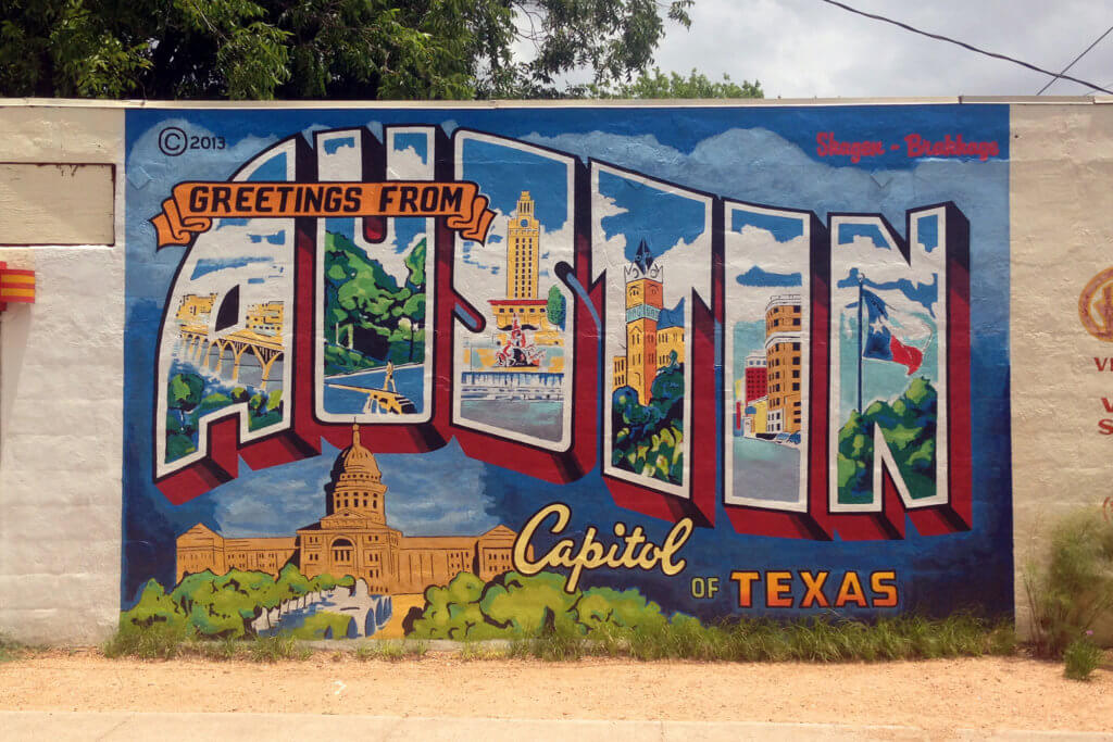 Mural advertising Austin, Texas. Ad reads, "Greetings from Austin, Capital of Texas"