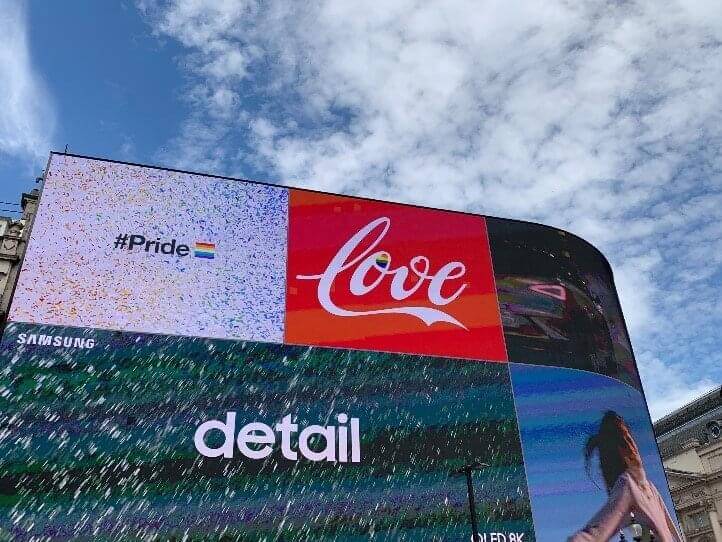 Bright billboards depicting different brands during pride month.