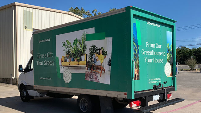 An image of a truck-side advertisement for Bloomscape.