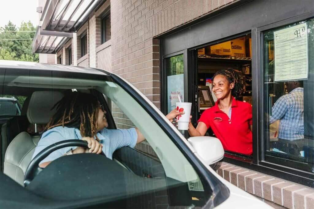 Photo of driver getting drive-thru fast food.
