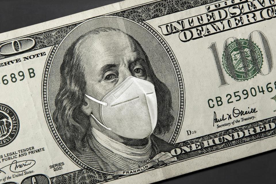 Image of $100 U.S. bill with mask photoshopped onto Benjamin Franklin's face.