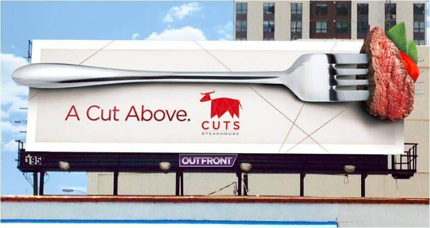 Creative restaurant billboard advertisement by CUTS Steakhouse. Ad says "A Cut Above."