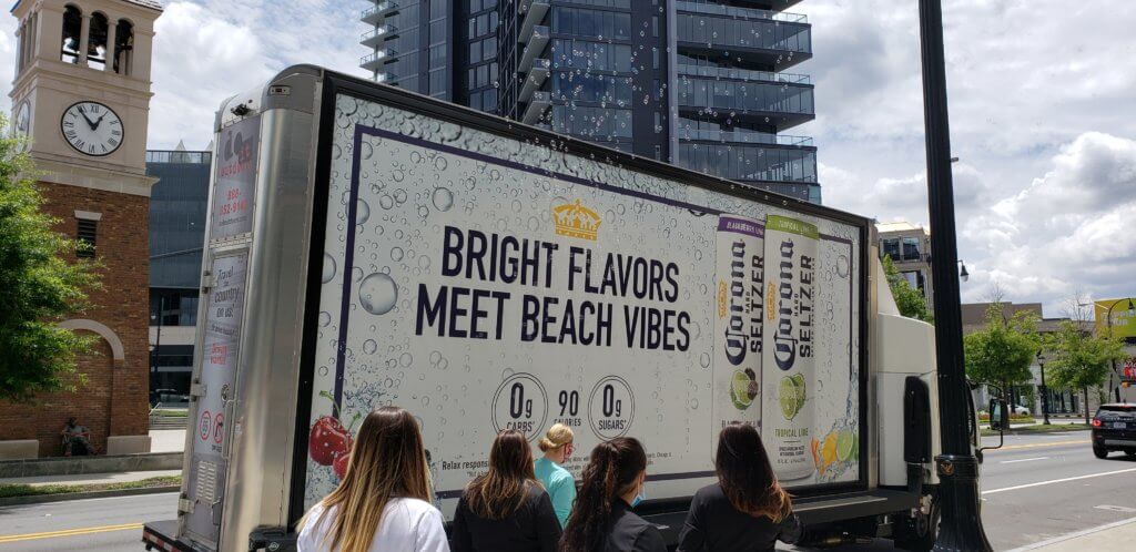 An image of a mobile ad for Corona Seltzer's. The ad shows the cans and a bunch of bubbles that actually float up above the truck.