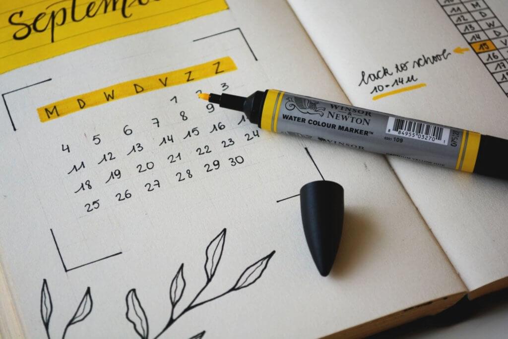 Calendar with days of the week highlighted with a yellow highlighter.