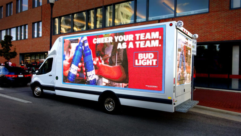 A Bud Light truck-side ad with the message "Cheer your team, as a team".