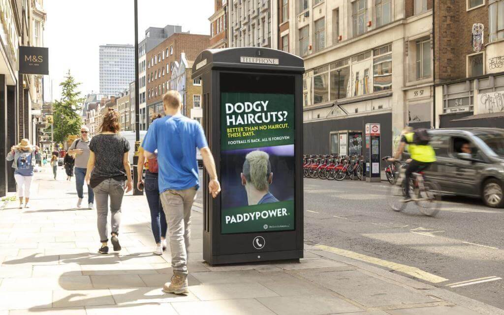 Image of bus shelter advertisement from PaddyPower saying "Dodgy haircuts? Better than no haircut, these days"