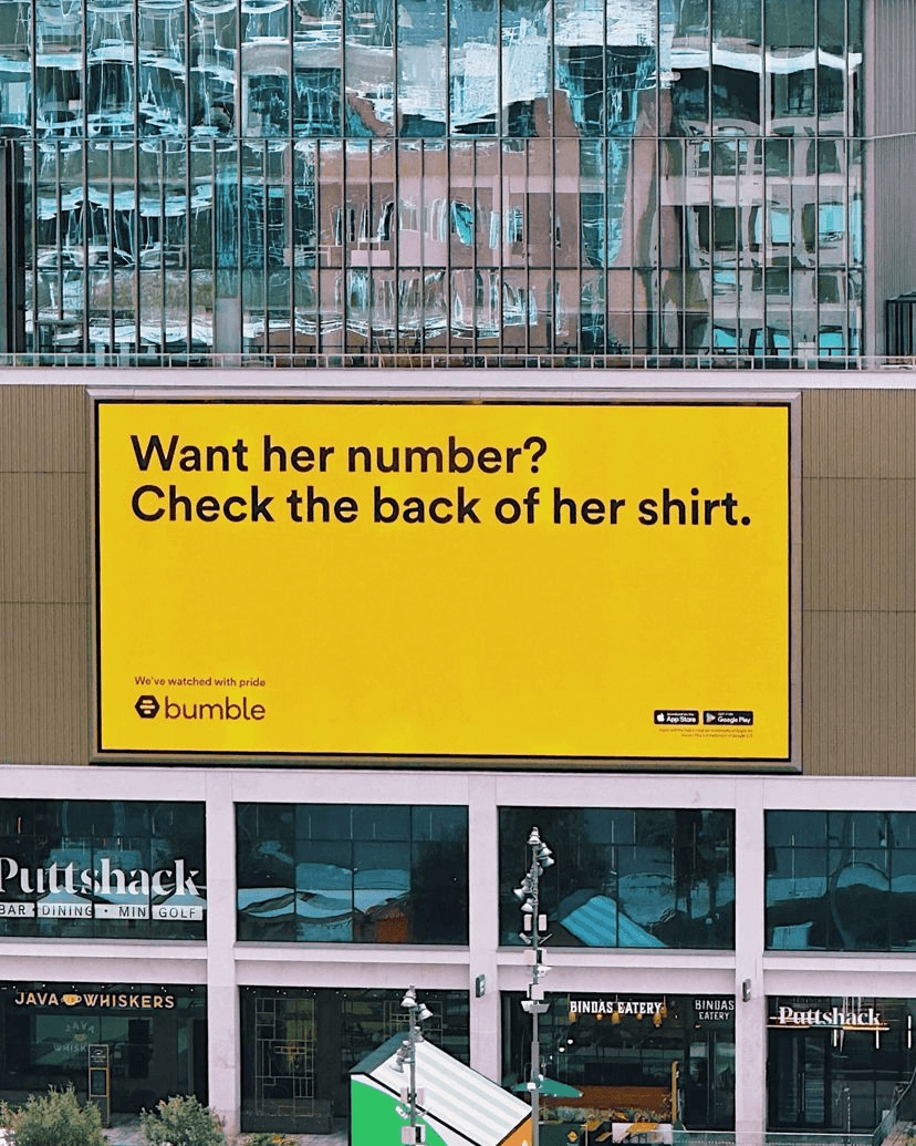 Bumble's OOH advertising billboard in support of Women's World Cup 2023. The billboard reads ' Want her number? Check the back of her shirt.' 