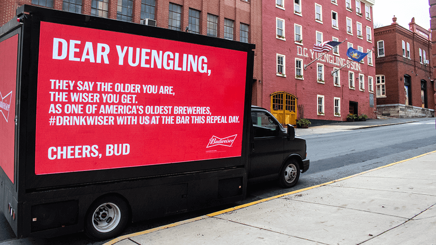 Budweiser's digital truck-side campaign targeting its competitors with personalized messages.